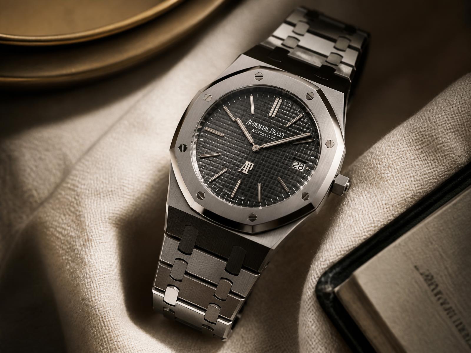 Luxury steel sports watch photographed on ivory linen